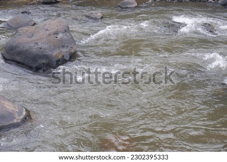 Mountain river with clear water. The rapid flow of a mountain river