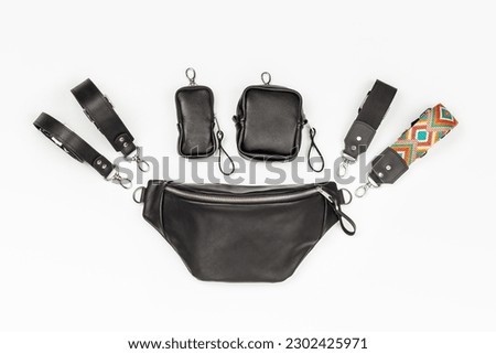 Black Genuine Leather Banana Fanny Pack with Four Kinds of Attachable Straps and Two mini Coin Purses. Customizable Bag Flat Lay on Gray Background