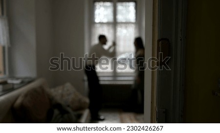 Blurred shot of couple arguing at home. Candid moment of husband and wife fighting each other. Person threatening the other in discussion Royalty-Free Stock Photo #2302426267
