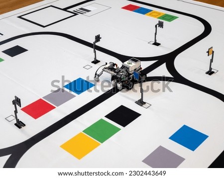 Line Following Robot is doing task to move from one point to another on the mat, selective focus. Programmable robots