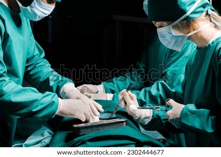Doctor and assistant nurse operating for help patient from dangerous emergency case . Surgical instruments on the sterile table in the emergency operation. Health care and Medical concept.