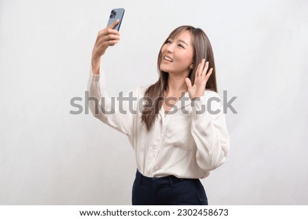 A Young asian woman using smartphone over white background, technology concept. 