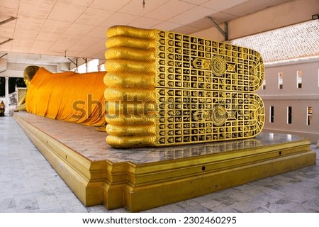Sculpture and carving art foot of buddha reclining attitude statue of Wat Ku or Phra Nang Rua Lom temple for thai people traveler travel visit and respect praying blessing holy in Nonthaburi, Thailand Royalty-Free Stock Photo #2302460295