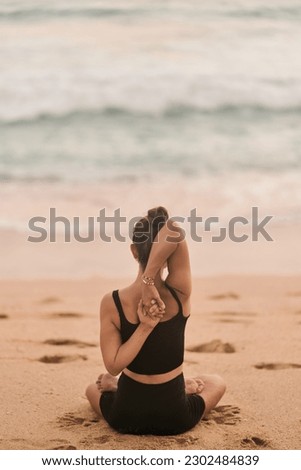 Beautiful girl doing yoga at the beach. High quality photo Royalty-Free Stock Photo #2302484839