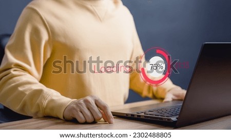 Adult man using a laptop computer for download software and waiting to loading digital technology data form website, very slow internet form wifi. Concept of waiting for load of loading symbol.