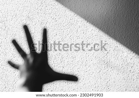 Light falling from a window onto a wall with paper abstract wallpaper. Abstract background. black and white photography