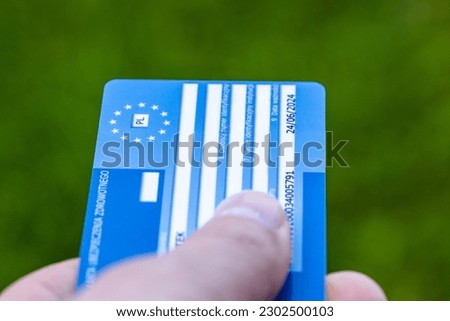 European health insurance card held in hand, Concept, EU document confirming the right to treatment outside of your own country, Travel insurance for Europeans traveling to EU and EFTA countries Royalty-Free Stock Photo #2302500103
