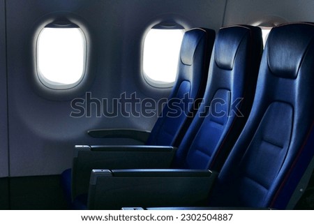 deserted economy class airplane seats rows Royalty-Free Stock Photo #2302504887