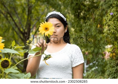 Portrait of happy attractive woman enjoying sunflower flowers in sunny summer field. Spring and summer background banner. Horizontal photo banner for website header design
