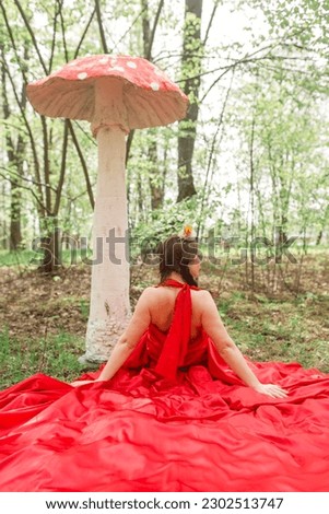 woman in red dress with big mushroom 