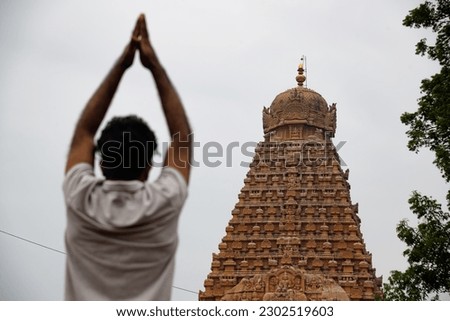 Indian men praying with his folded hands on Temple Background. Hindu god Work ship Concept. Lord Shiva Temple and mahashivratri. Royalty-Free Stock Photo #2302519603
