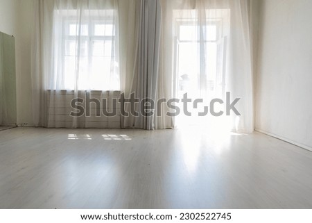 a large bright room with large windows hall room