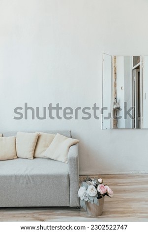 a bright room with sofa and flower interior room