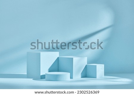 Blue background for product presentation with shadows and light. Empty podiums. Mockup. Royalty-Free Stock Photo #2302526369