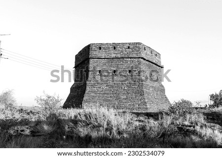 A blockhouse on a hill guarded Prieska during the Second Boer War. It was built from semi-precious tigers eye stones. Monochrome Royalty-Free Stock Photo #2302534079
