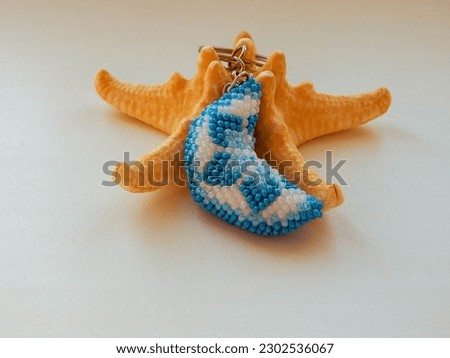 Bead colorful key chain and sea coast. Colorful key chain and sea starfish
