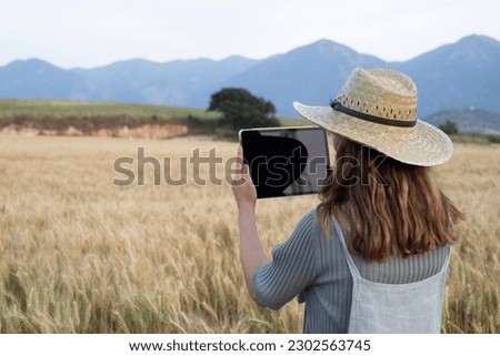 farmer woman checking the farm field 