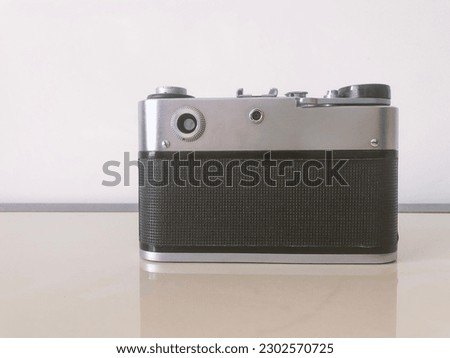 Vintage retro photo camera camera is an old device that shoots on film. Metal case with plastic inserts. Hobby and profession.