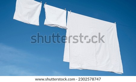 Clothes hanging to dry on a laundry line Royalty-Free Stock Photo #2302578747