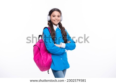 School girl, teenager student in headphones on white isolated studio background. School and music education concept. Back to school.
