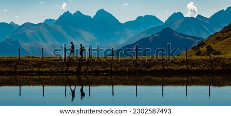 Beautiful alpine summer view with reflections of hikers in a lake at the famous Kanzelwand summit, Riezlern, Vorarlberg, Austria Royalty-Free Stock Photo #2302587493