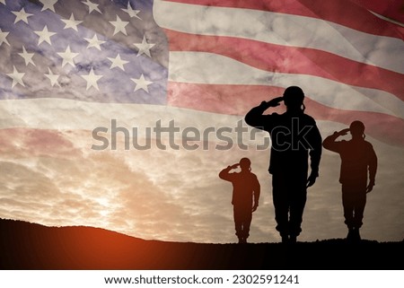 Silhouettes of soldiers saluting on background of sunset or sunrise and USA flag. Greeting card for Veterans Day, Memorial Day, Independence Day. America celebration. Royalty-Free Stock Photo #2302591241
