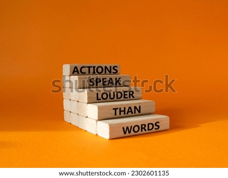 Actions speak louder than Words symbol. Wooden blocks with words Actions speak louder than Words. Beautiful orange background. Business and Actions concept. Copy space.