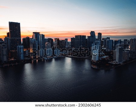 Aerial view of downtown Miami skyline at sunset featuring Brickell Key by drone