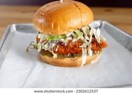 A view of a Nashville chicken burger. Royalty-Free Stock Photo #2302612537