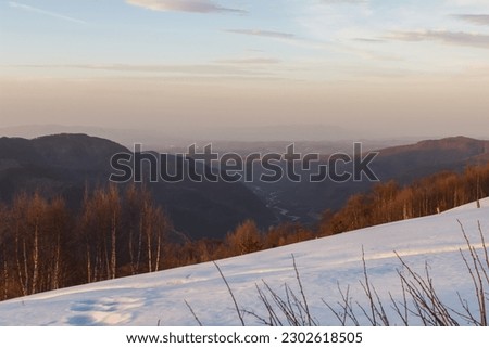 Sunset with a view of the snow-capped mountain peaks of Arkhyz near the BTA Royalty-Free Stock Photo #2302618505