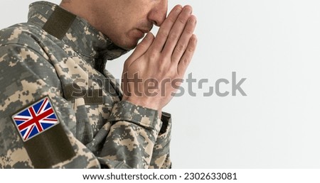 a British soldier prays. Remembrance Day.