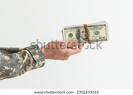Army soldier holding money against white background