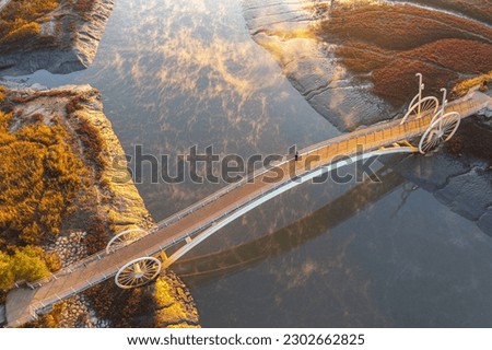 Aerial and sunrise view of a man standing on Misaeng's Bridge over fog of the sea with mud flat and tidal channel near Siheung-si, South Korea
 Royalty-Free Stock Photo #2302662825