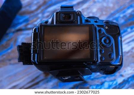 DSLR camera isolated on floor background. Black DSLR camera isolated.