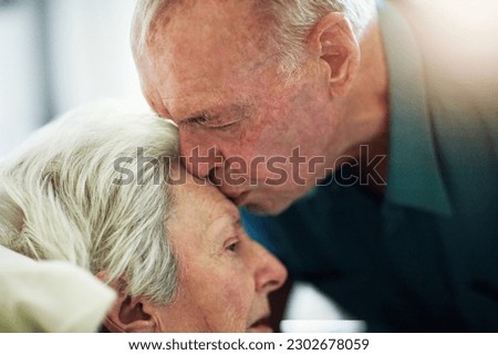 Senior, kiss and couple in hospital for healthcare, visiting sick patient and hope for recovery. Clinic, elderly man and woman kissing on forehead with love, care and empathy, kindness and comfort. Royalty-Free Stock Photo #2302678059