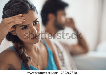 Unhappy, upset or sad with a couple arguing on a sofa in their home living room about an affair or breakup. Depression, abuse or domestic violence with a woman thinking about divorce after a fight Royalty-Free Stock Photo #2302678181