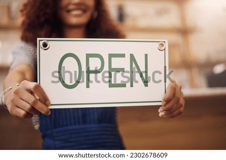 Open sign, hands and woman in small business, store and advertising news of retail shopping time, banner and trading information. Closeup, shop owner and board for opening, welcome and cafe signage
