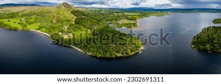 Panoramic aerial view of Conic Hill and Balmaha on the shores of Loch Lomond (Highlands, Scotland) Royalty-Free Stock Photo #2302691311