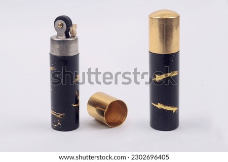 Long cylindrical vintage manual lighter, in various colors, gold,black and stainless