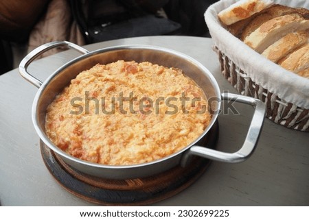 Turkish Menemen omelet in a frying pan. . Royalty-Free Stock Photo #2302699225