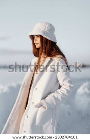 pretty woman in a white coat in a hat winter landscape walk nature