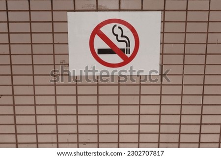 No smoking warning sign on the titled wall