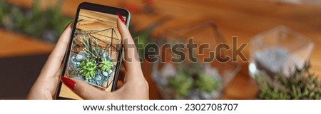 Close up of florist taking picture with her plants for publishing in social media