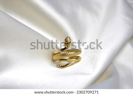 Cool golden snake ring with a white background