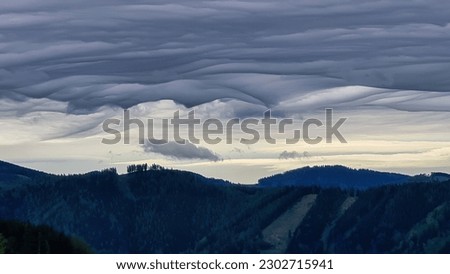 Mystical clouds and scenic view from mount Roethelstein near Mixnitz in Styria, Austria. Landscape of green alpine meadow and bushes in the valley of Grazer Bergland in Styria, Austria. Cloudscape