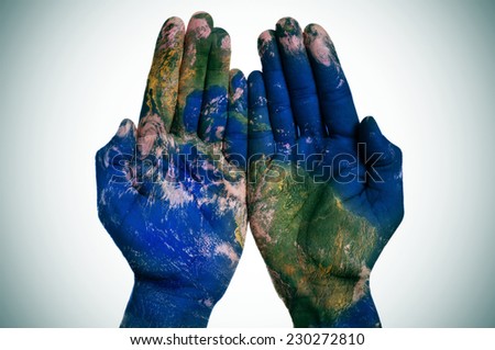 a world map in open man hands (Earth map furnished by NASA) Royalty-Free Stock Photo #230272810