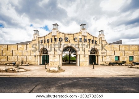 The San Angelo Visitor Center stands tall in the bustling Texas city, its entrance framed by a cloud-filled sky. Royalty-Free Stock Photo #2302732369