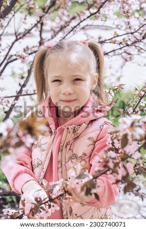 Blonde girl and spring flowering tree