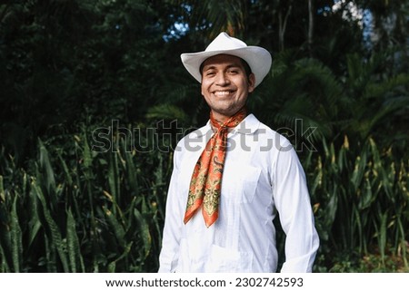 Latin man wearing traditional Mexican custom called "jarocho" traditional from Veracruz Mexico Latin America, young hispanic people in independence day or cinco de mayo parade or cultural Festival Royalty-Free Stock Photo #2302742593