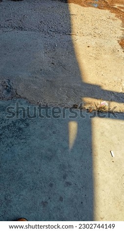 shadow of sunlight with cigarette butt on floor